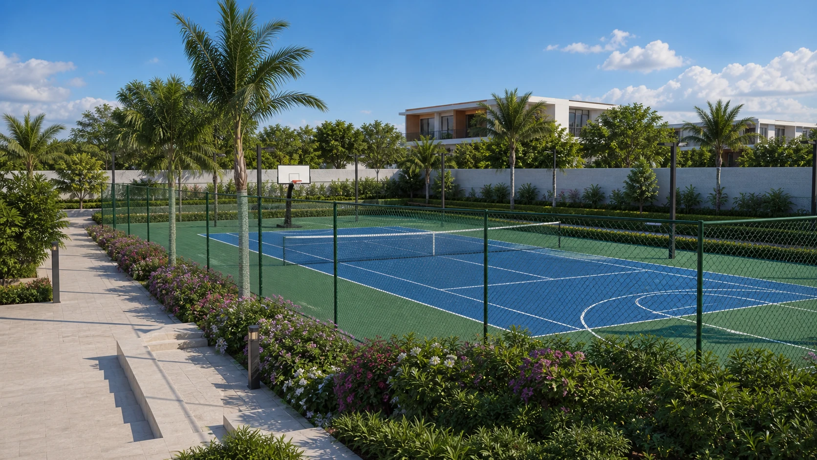 A bright daylight tennis and basketball court framed by palms, villas and flowering planting